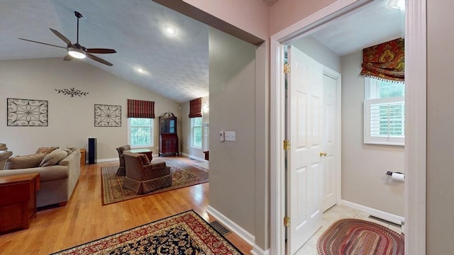 659 Sherman Farm Rd, Burrillville, RI 02830 - living area with healthy amount of natural light, a ceiling fan, vaulted ceiling, light wood finished floors, and baseboards