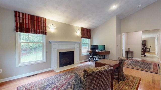 659 Sherman Farm Rd, Burrillville, RI 02830 - living area with wood finished floors, lofted ceiling, a fireplace with flush hearth, and baseboards
