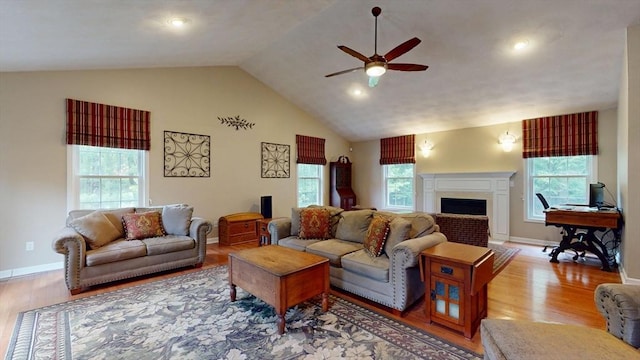 659 Sherman Farm Rd, Burrillville, RI 02830 - living area with ceiling fan, wood finished floors, healthy amount of natural light, a fireplace, and high vaulted ceiling