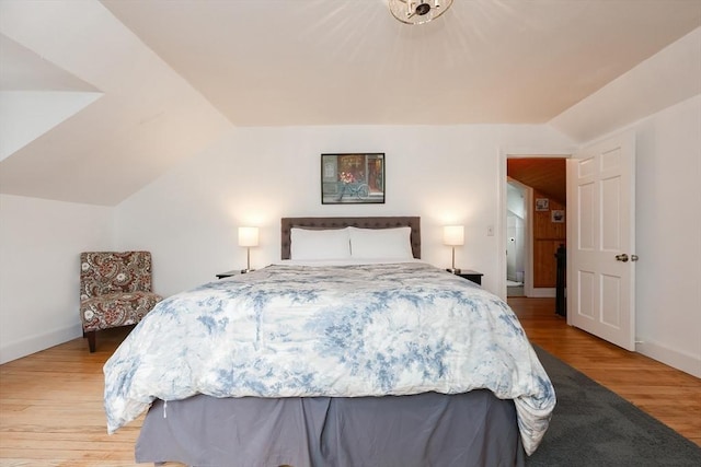 bedroom featuring lofted ceiling and light hardwood / wood-style floors