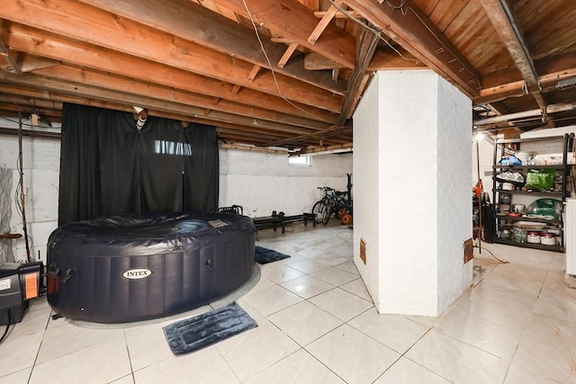 basement with light tile patterned flooring