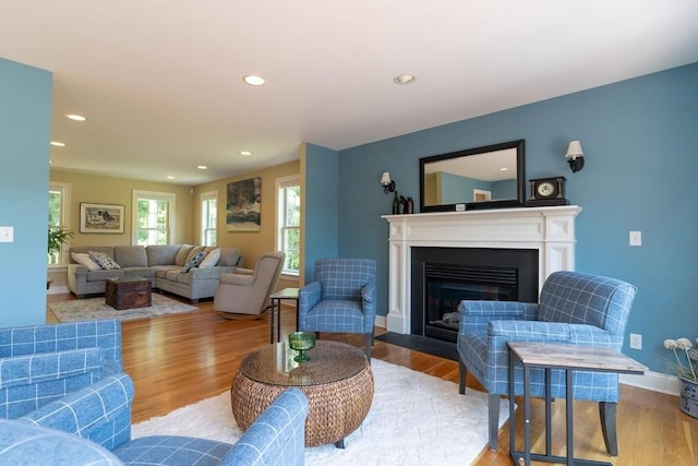 9 Old Poor Farm Rd, Ware, MA 01082 - living room featuring a glass covered fireplace, wood finished floors, and recessed lighting