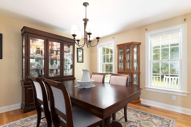 9 Old Poor Farm Rd, Ware, MA 01082 - dining space featuring a chandelier, light wood-style flooring, and plenty of natural light