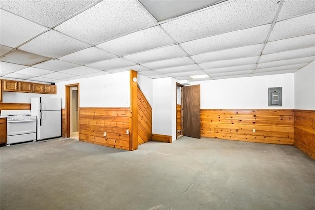 bonus room with wooden walls and electric panel