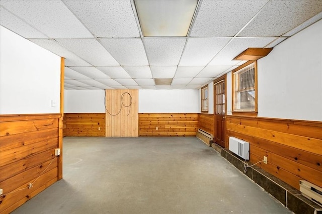 bonus room featuring a baseboard radiator and wood walls