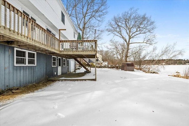 yard covered in snow with a wooden deck