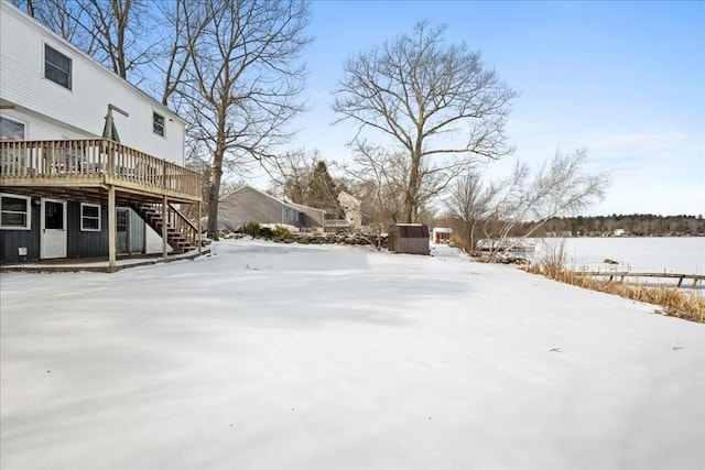 yard covered in snow with a wooden deck