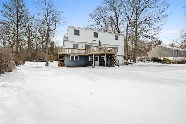 snow covered property with a deck