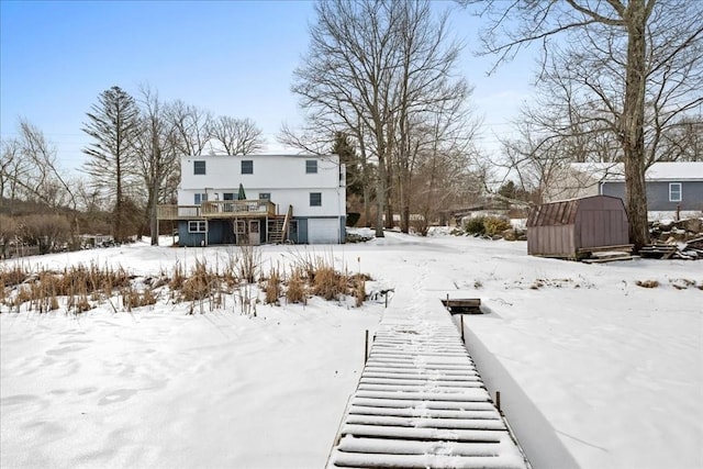 snow covered property with a wooden deck