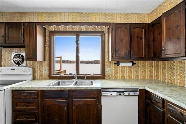 kitchen with white appliances, sink, and dark brown cabinets