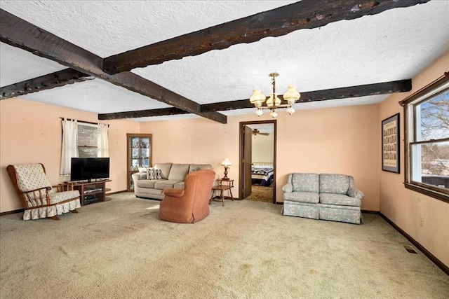 carpeted living room with beam ceiling, a chandelier, and a textured ceiling