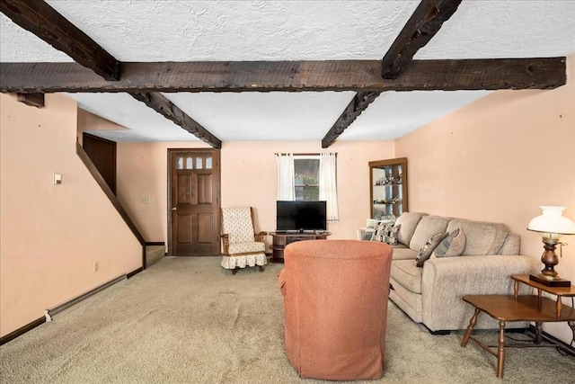 living room with beamed ceiling, light carpet, and a textured ceiling