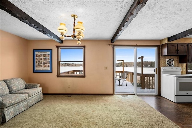 living room with beamed ceiling, a healthy amount of sunlight, an inviting chandelier, and a textured ceiling