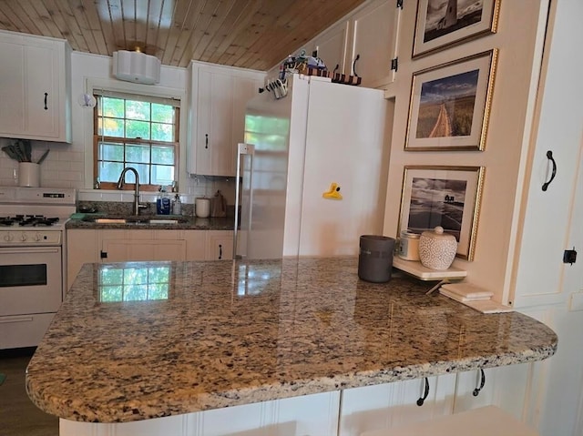 kitchen featuring decorative backsplash, refrigerator, white gas range, and wooden ceiling