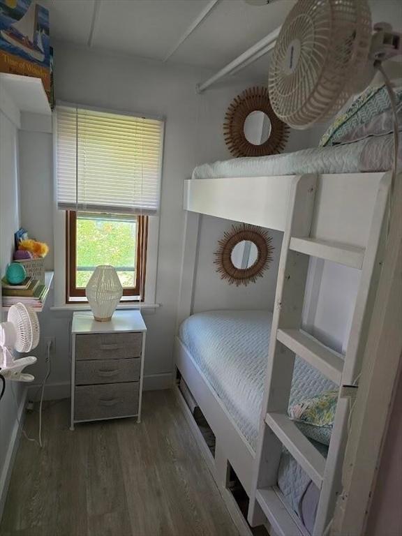 bedroom with wood finished floors and baseboards