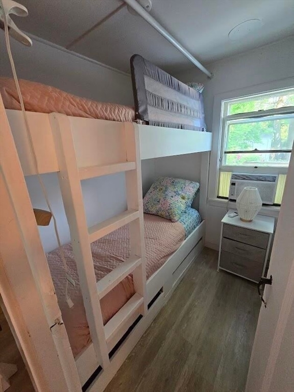 bedroom featuring hardwood / wood-style flooring and cooling unit