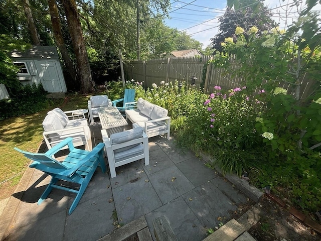 view of patio / terrace featuring an outdoor living space and a shed