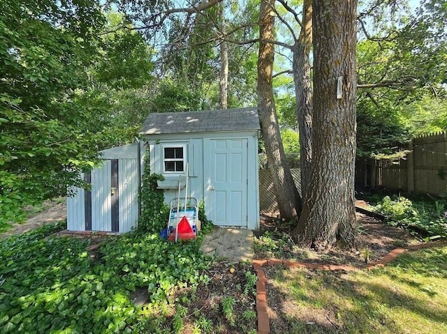 view of shed featuring fence
