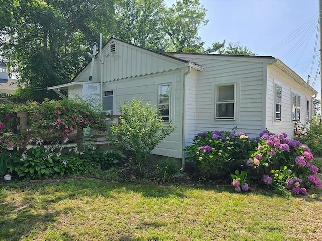view of home's exterior featuring a lawn and board and batten siding
