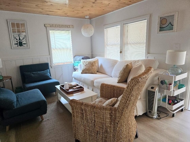 living room with wood ceiling, a wealth of natural light, and light wood-type flooring