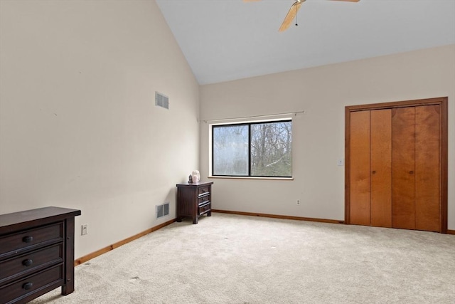 unfurnished bedroom featuring light carpet, high vaulted ceiling, and ceiling fan