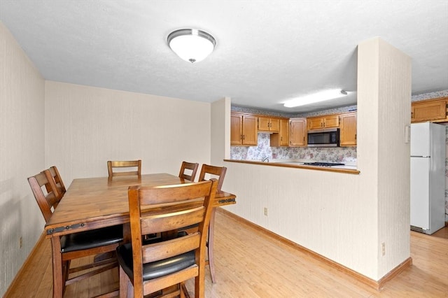 dining room with light wood-type flooring