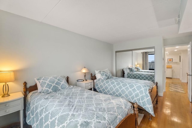 49 Melrose St Unit 4E, Melrose, MA 02176 - bedroom featuring light wood-style flooring, a closet, and baseboards