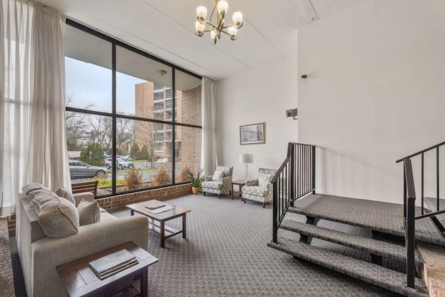 49 Melrose St Unit 4E, Melrose, MA 02176 - living room featuring expansive windows, stairway, carpet flooring, and a chandelier