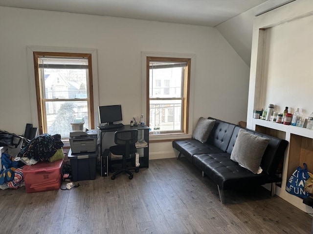 office space with a wealth of natural light, baseboards, lofted ceiling, and wood finished floors