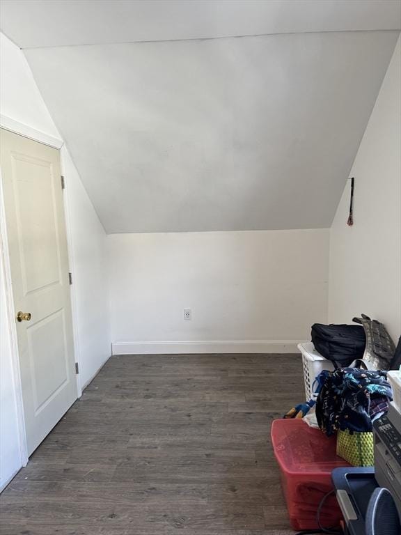 bonus room with vaulted ceiling, dark wood-style floors, and baseboards