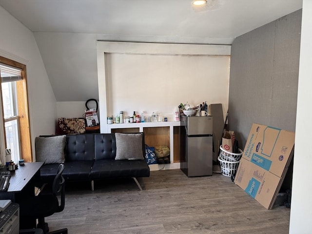 living room with lofted ceiling and wood finished floors