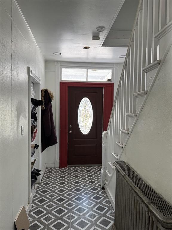 entrance foyer featuring tile patterned floors and stairs