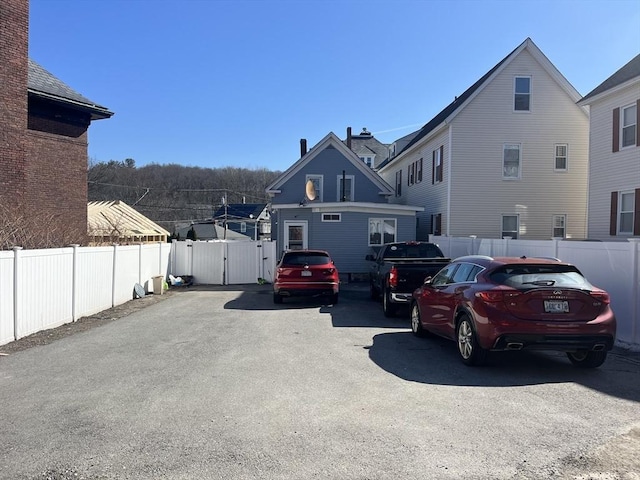 view of car parking featuring a gate and fence