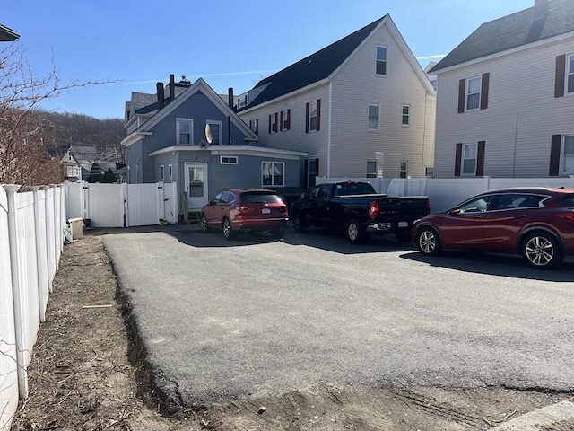 view of front of home featuring fence and a gate