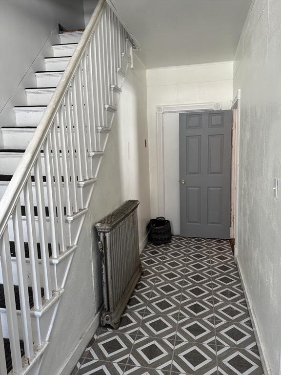 stairway with tile patterned floors