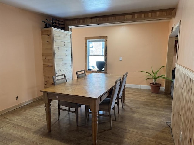 dining space featuring baseboards and wood finished floors