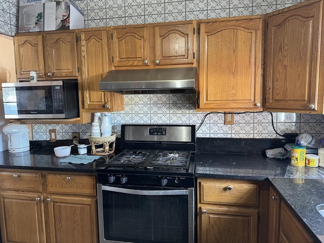 kitchen featuring under cabinet range hood, stainless steel appliances, tasteful backsplash, and brown cabinetry