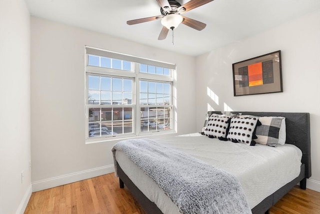 bedroom with hardwood / wood-style flooring and ceiling fan