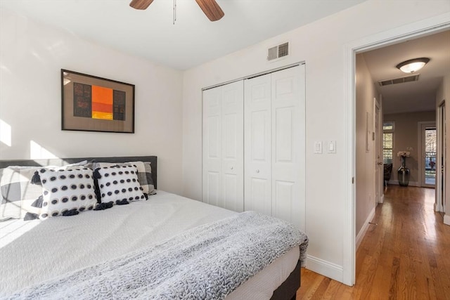 bedroom featuring hardwood / wood-style flooring, a closet, and ceiling fan