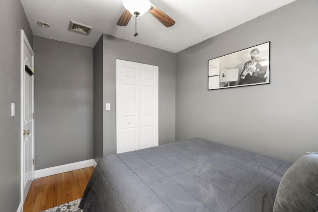 bedroom featuring ceiling fan, a closet, and light wood-type flooring