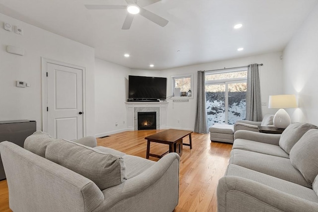 living room featuring ceiling fan and light wood-type flooring