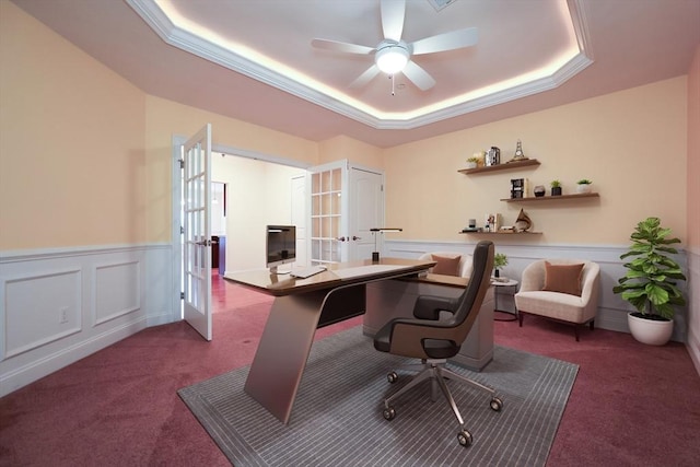 carpeted office with ceiling fan, french doors, crown molding, and a tray ceiling