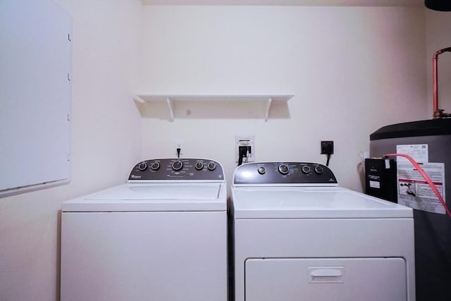 washroom with washing machine and dryer and water heater