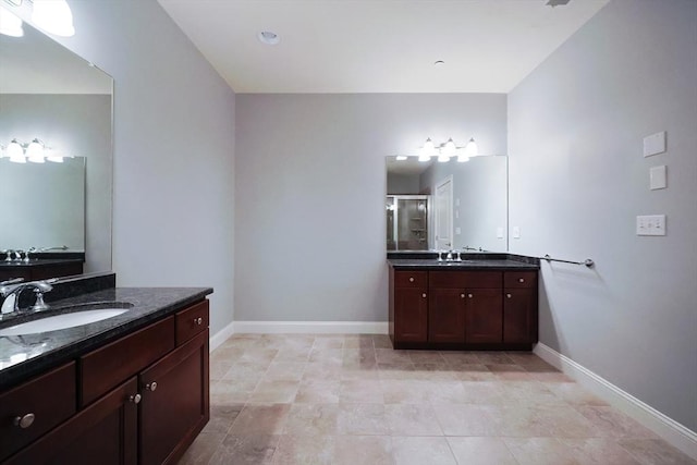 bathroom with vanity and a shower with shower door