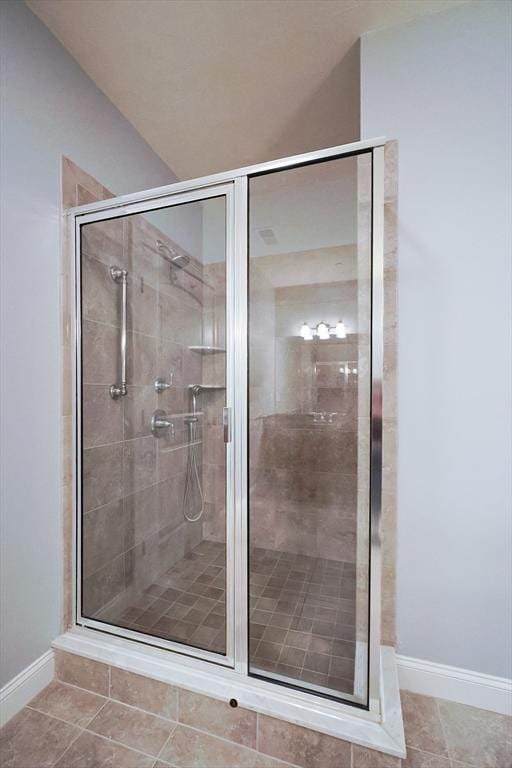 bathroom featuring tile patterned flooring and a shower with shower door