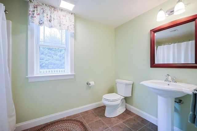 bathroom featuring tile patterned floors, toilet, and sink