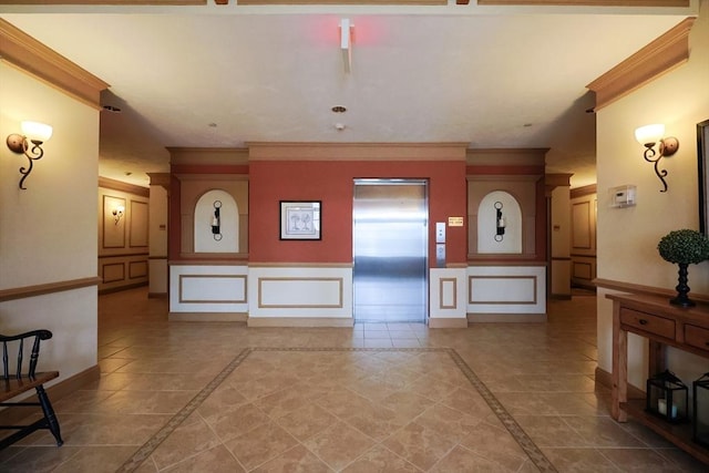 interior space with tile patterned flooring, crown molding, and elevator