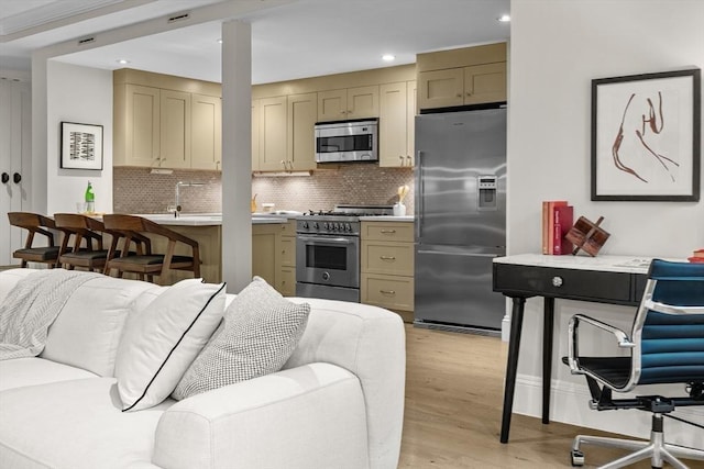 407 Shawmut Ave Unit 1, Boston, MA 02118 - kitchen with appliances with stainless steel finishes, open floor plan, light countertops, backsplash, and recessed lighting