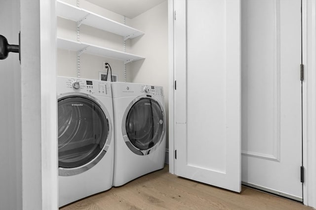 407 Shawmut Ave Unit 1, Boston, MA 02118 - washroom featuring light wood-style floors and washer and dryer