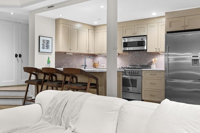 407 Shawmut Ave Unit 1, Boston, MA 02118 - kitchen featuring stainless steel appliances, light countertops, recessed lighting, decorative backsplash, and open floor plan
